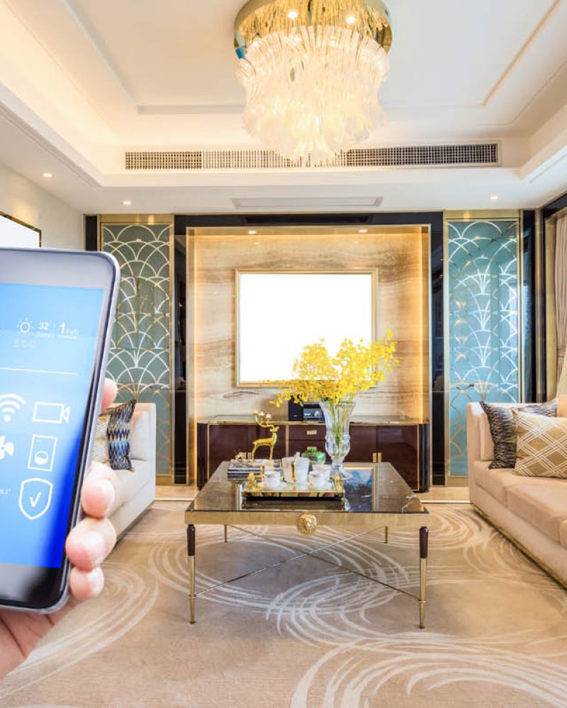 mobile phone with smart home app in modern living room